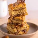Thick slices of pumpkin cinnamon roll focaccia stacked on a plate
