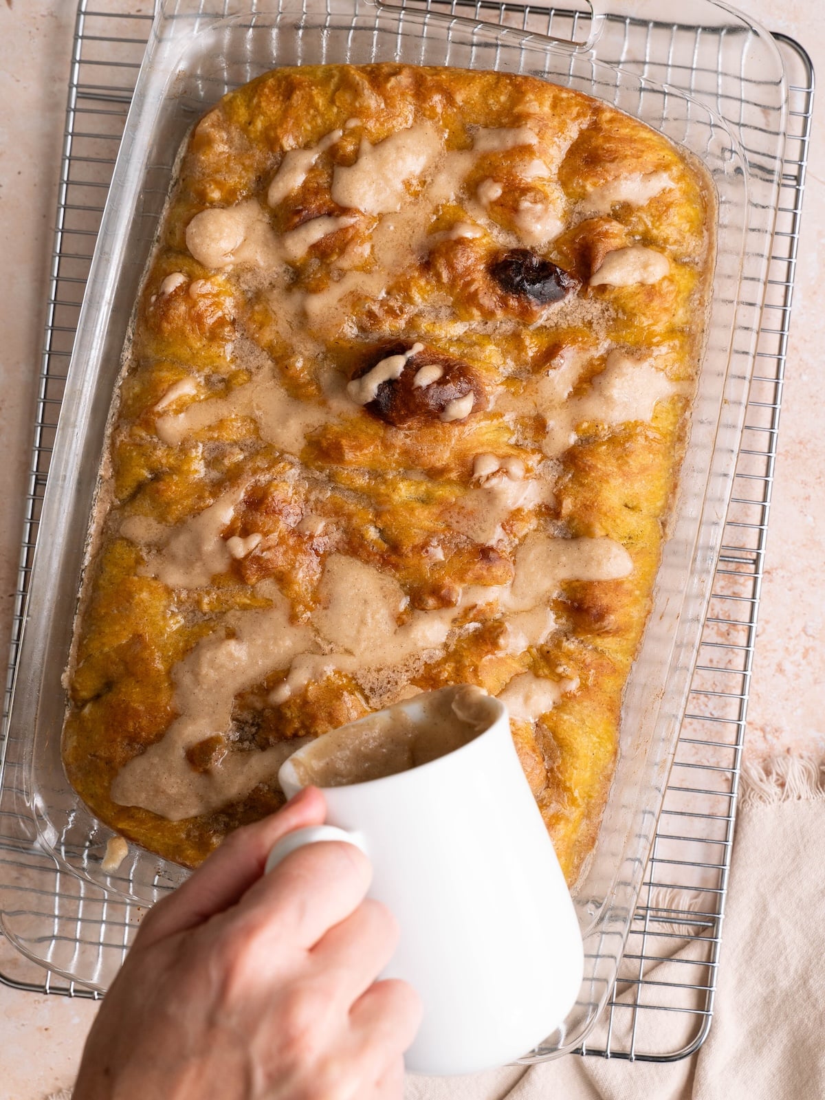 Drizzling maple glaze over pumpkin focaccia