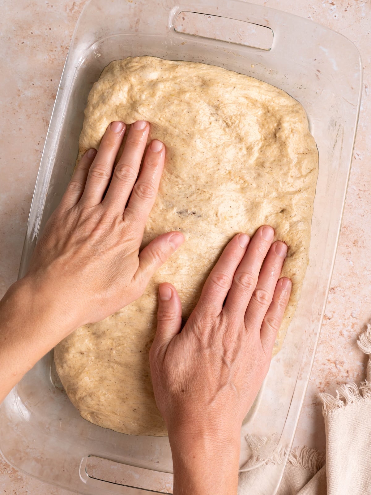 Stretching focaccia dough with hands