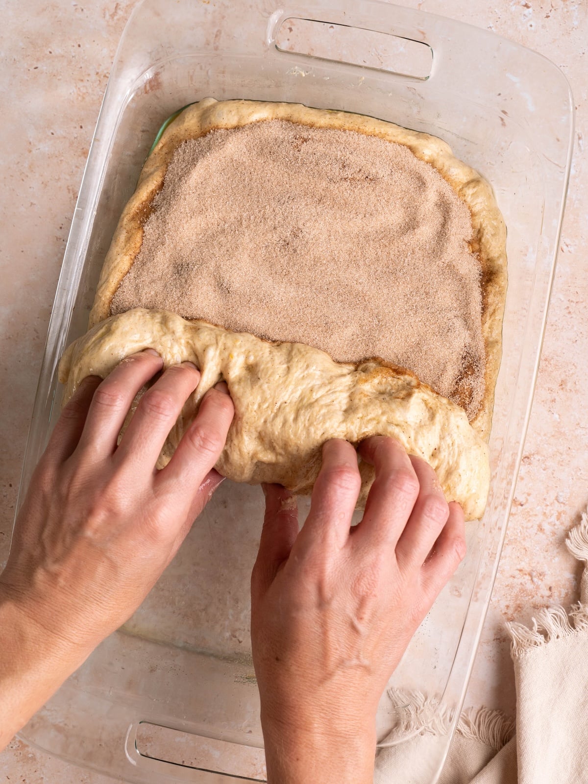 Rolling pumpkin spice focaccia dough into a log
