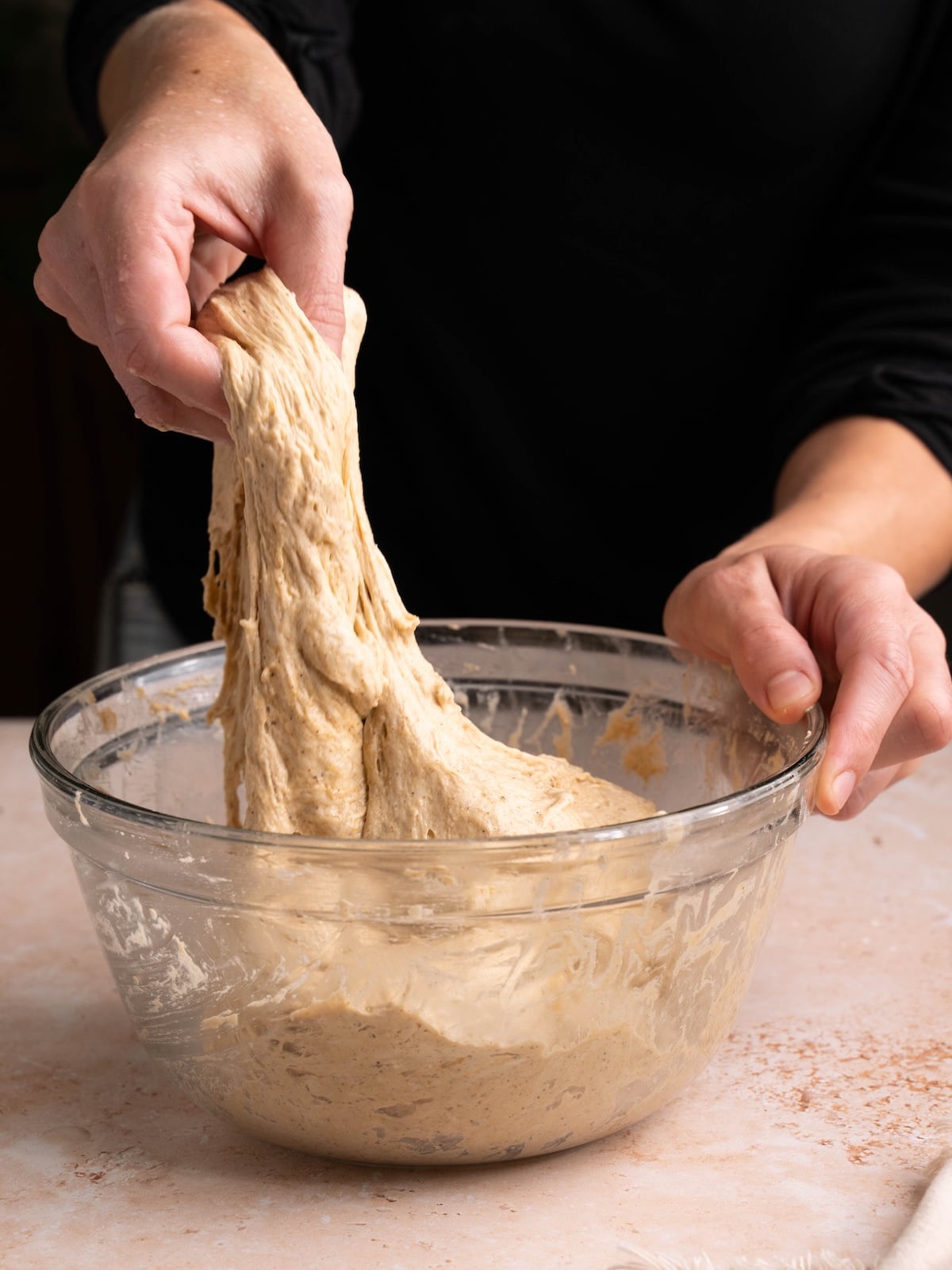 Stretching pumpkin focaccia dough